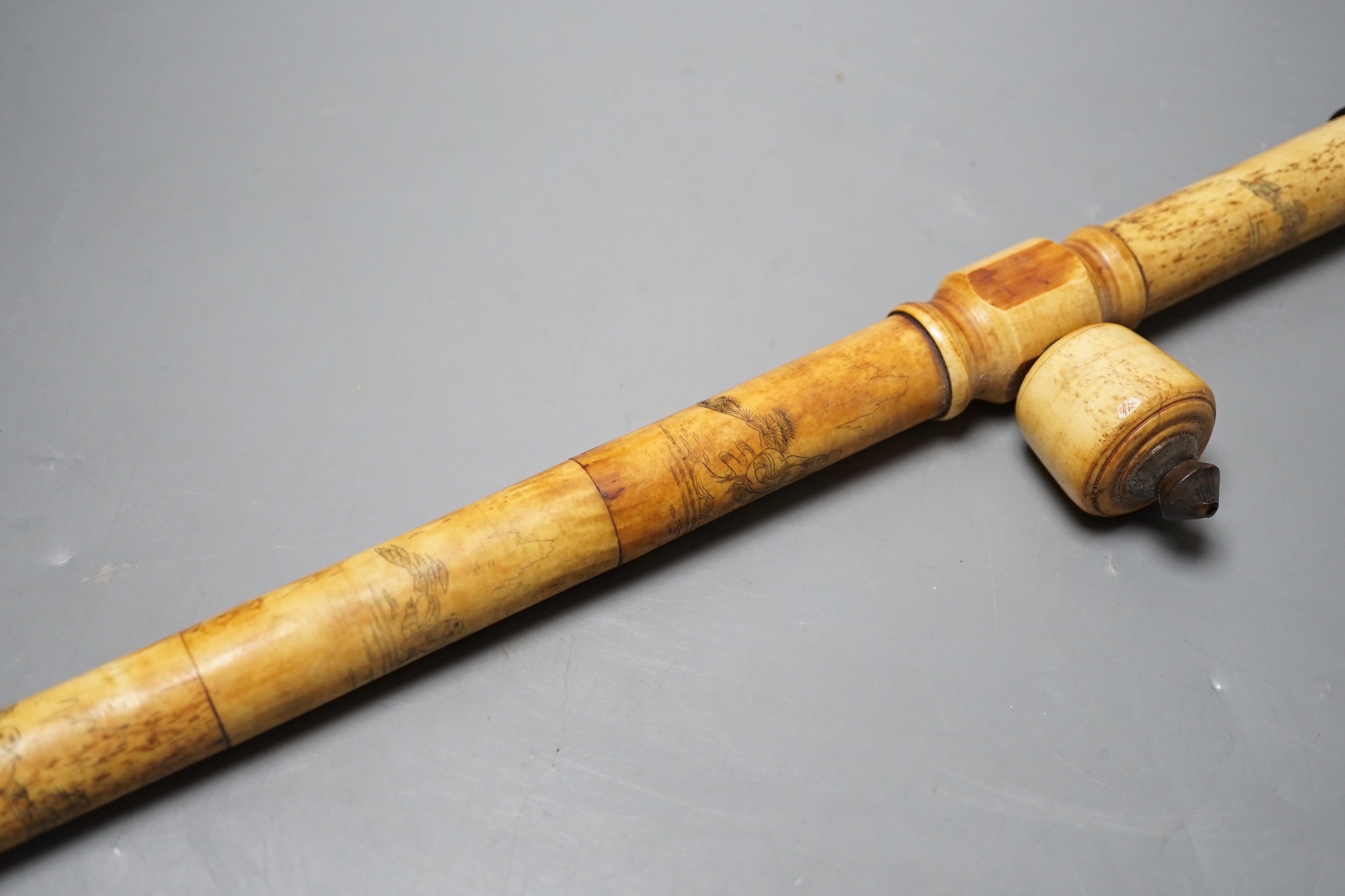 A Chinese bone opium pipe with figural decoration, 46cm wide